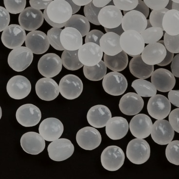 Close-up of translucent polyketone (POKETONE) granules, Hyosung’s high-performance engineering plastic