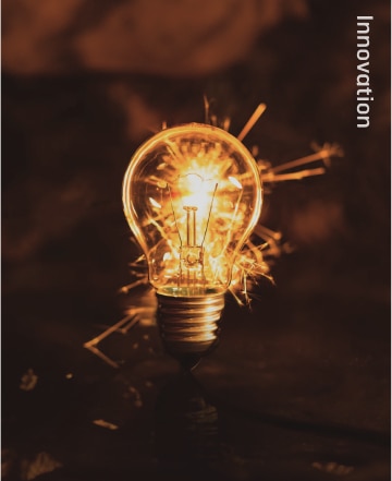 A glowing light bulb bursting with sparks, representing Hyosung’s core value of driving innovation