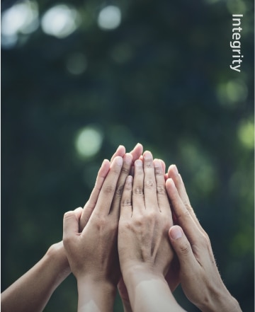 Multiple hands joined in unity, expressing trust, collaboration, and shared purpose within Hyosung’s values
