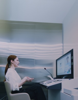 Customer receiving remote financial consultation using Hyosung TNS’s world-first digital kiosk solution, Digital Desk®
