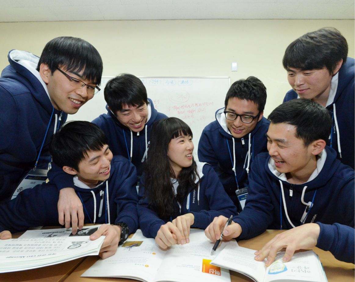New Hyosung employees actively participating in a group discussion during the corporate training program