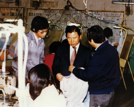 Hyosung management inspecting textile production lines and checking product quality with on-site employees